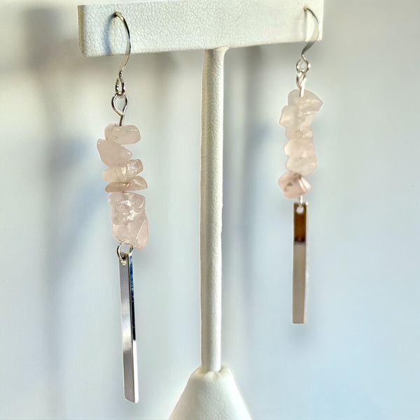 Rose Quartz Silver Rectangle Dangle Earrings on a white earring stand